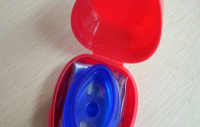 Heartshape plastic box with CPR face shield image